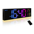 A rectangular digital wall clock with a black face and glowing LED numbers in blue, pink, and green. The clock shows the temperature and time settings.
