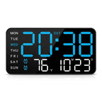 A rectangular digital alarm clock with a black face and glowing blue and white LED displays.