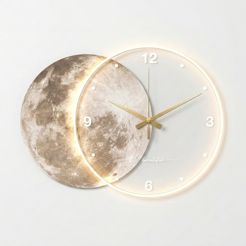 A modern wall clock featuring a moon face design, with one overlapping circular section showing a detailed moon texture and the other section displaying a minimalist white dial with gold hands and a glowing warm light around the outer ring.
