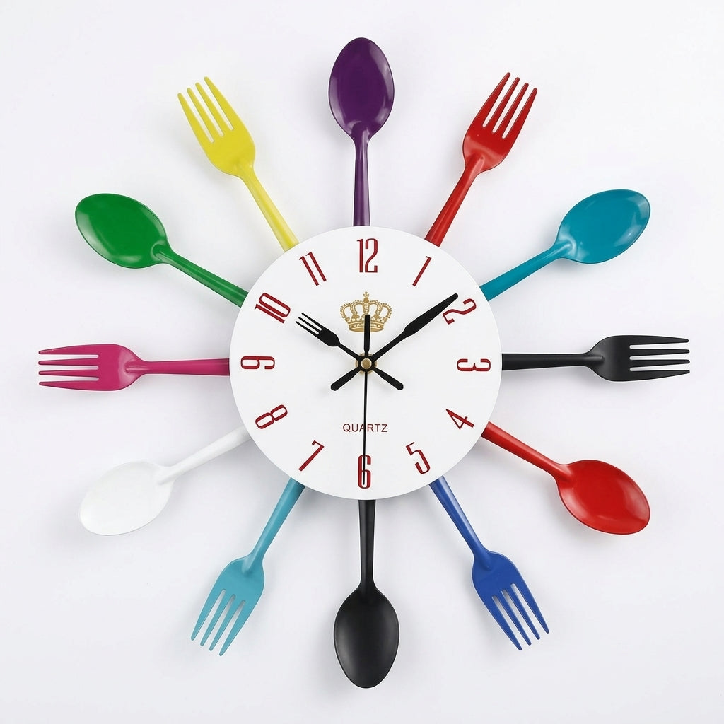 A colorful wall clock shaped like a clock face surrounded by plastic cutlery. The numbers 1 through 12 are represented by spoons and forks in green, yellow, purple, red, teal, black, pink, white, blue, and dark blue, arranged in a circular pattern around a white center dial with black hands and a small gold crown detail.