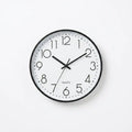 A minimalist quartz wall clock with a black frame, white face, and black numerals and hands.